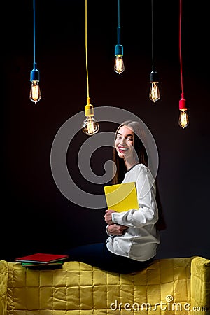 Young creative student with colorful lamps and books Stock Photo