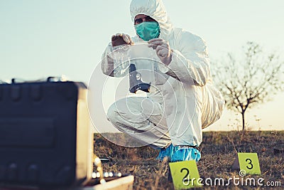 Criminologist investigates a crime scene. Stock Photo