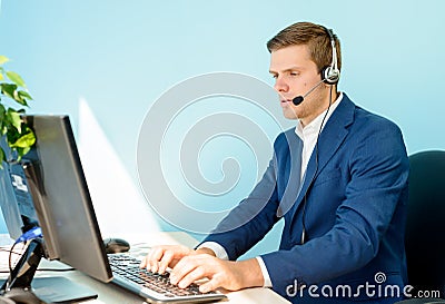 Young Customer Support Phone Operator with Headset Working in the Office. Stock Photo