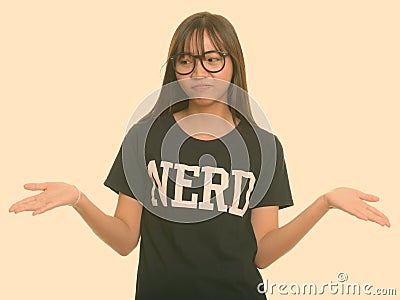 Young cute Asian nerd teenage girl shrugging shoulders Stock Photo