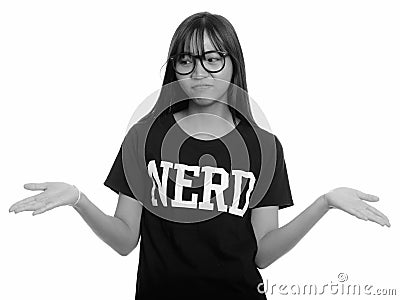 Young cute Asian nerd teenage girl shrugging shoulders Stock Photo