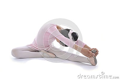 Young cute Ballerina girl stretching wearing pink Ballet tutu Stock Photo