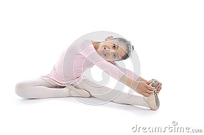 Young cute Ballerina girl stretching wearing pink Ballet tutu Stock Photo