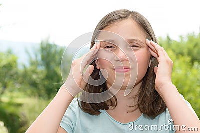 Young cute Caucasian girl have a headache Stock Photo