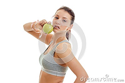 Young cute girl holding a Green Apple and looks into the camera close-up Stock Photo