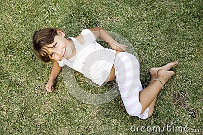 Young cute girl lying on the grass Stock Photo