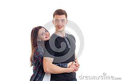 Young cute girl smiling and hugging beautiful high guy Stock Photo