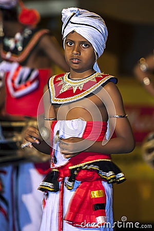 A young Cymbal Player or Thalampotakaruwo performs along the streets of Kandy in Sri Lanka during the Esala Perahera. Editorial Stock Photo