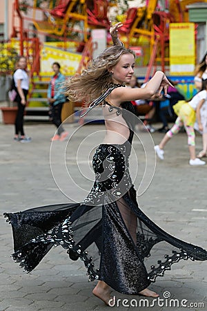 Young dancer in traditional dress, young woman dancing arabic dance, street group. The girl is dancing in public. The girl in Editorial Stock Photo