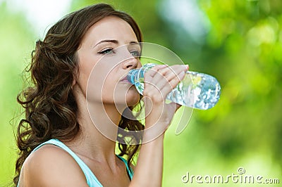 Young dark-haired woman drinking Stock Photo