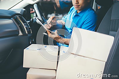 Young Delivery Man Checking Customer List On Tablet. Stock Photo