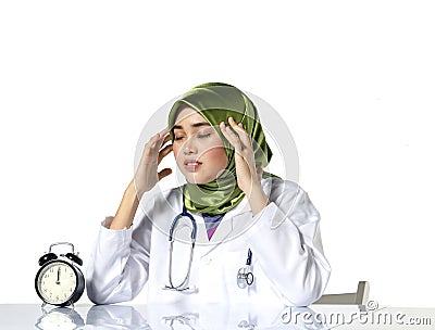 Young depressed hijab woman healthcare practitioner holding face in despair Stock Photo