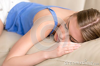 Young deprived sleeping woman lying asleep on sofa, close up Stock Photo