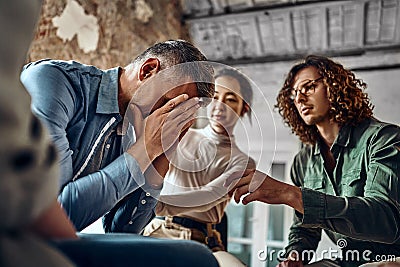 Young despair man crying during group therapy Stock Photo