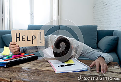 Young desperate student in stress working and studying holding a help sign Stock Photo