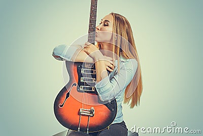 Woman kissing electric guitar devoted Stock Photo