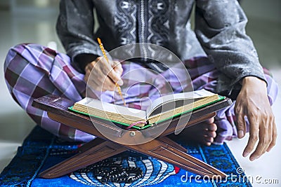 Young devout man reading Quran Stock Photo