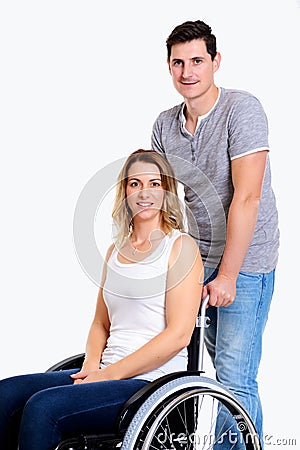 Young disabled woman in wheelchair and her husband Stock Photo