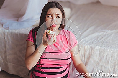 Young disgust female after trying piece of cake, healthy diet concept, pregnancy food Stock Photo
