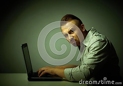 Young dissatisfied man working with laptop. Stock Photo