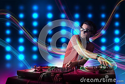 Young Dj mixing records with colorful lights Stock Photo