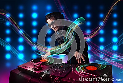 Young Dj mixing records with colorful lights Stock Photo