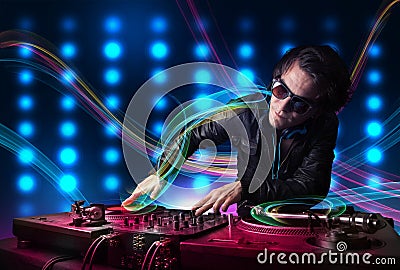 Young Dj mixing records with colorful lights Stock Photo