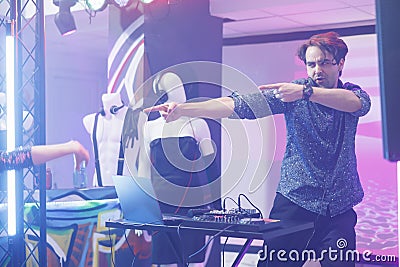 Dj pointing with fingers on stage Stock Photo