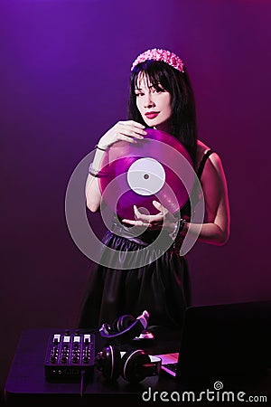 Dj headphone equipment disco girl party retro vintage ultraviolet mixer young woman vinyl glamor valentine`s day plastic pink Stock Photo