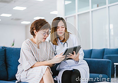 doctor consulting senior patient at health care clinic Stock Photo