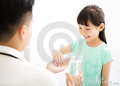 Young doctor gives the child medicine Stock Photo