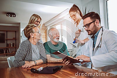 Young doctor during home visit senior people Stock Photo