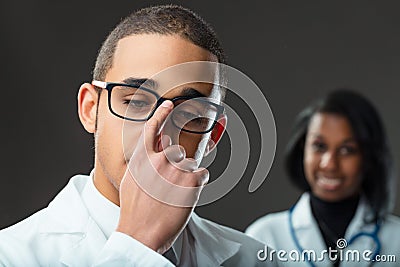 Young doctor's gesture belies deep-rooted workplace sexism Stock Photo