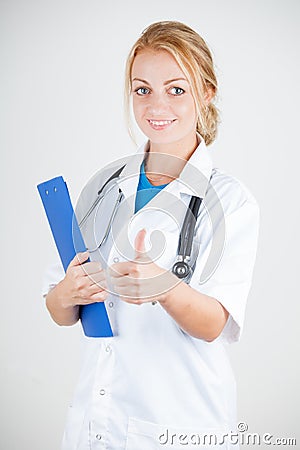 Young doctor with stethoscope giving thumbs up Stock Photo
