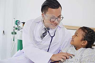 The doctor is treating the girl Stock Photo
