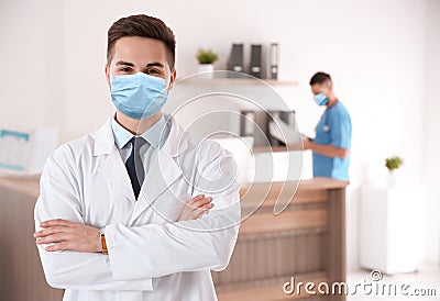 Young doctor wearing medical mask in clinic Stock Photo