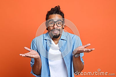 Young doubtful confused african american man spreading palms, saying i don't know Stock Photo