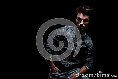 Young dramatic man resting on chair in studio Stock Photo