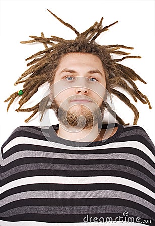 Young dreadlock man lies isolated Stock Photo