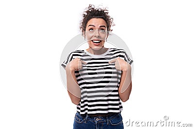 young dreamy well-groomed curly woman with black hair in a summer striped t-shirt Stock Photo