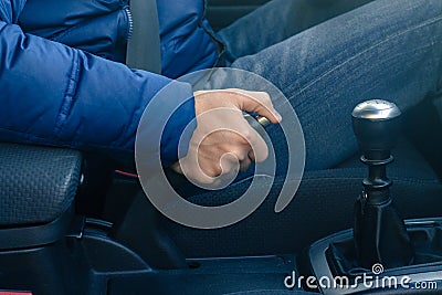 Young driver pulling the hand brake in car Stock Photo