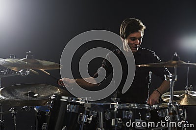 Young Drummer Playing Drum Kit In Studio Stock Photo