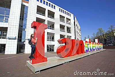 Young dutch woman with the letters I Amsterdam in the Netherlands Editorial Stock Photo