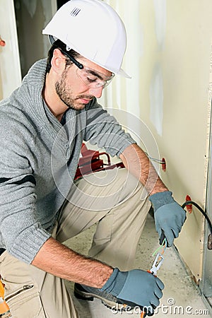 Young electrician using pliers Stock Photo