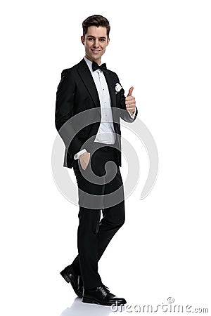 Young elegant groom smiling and making thumbs up sign Stock Photo