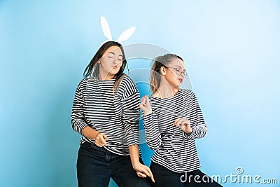 Young emotional women on gradient blue background Stock Photo