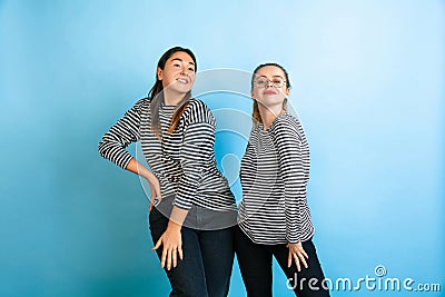 Young emotional women on gradient blue background Stock Photo