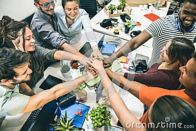 Young employee startup workers group stacking hands at start up office Stock Photo