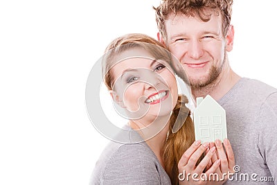 Young enamoured pair showing house symbol. Stock Photo