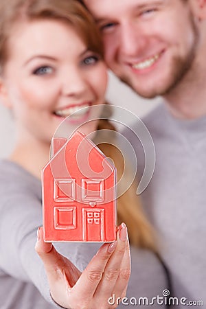 Young enamoured pair showing house symbol. Stock Photo
